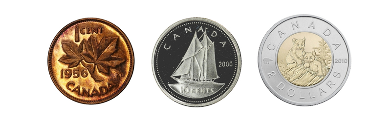 Three diverse Canadian coins: a 1956 bronze 1-cent penny with a maple leaf, a 2000 silver 10-cent dime with the Bluenose schooner, and a 2010 bimetallic 2-dollar coin with polar bears.
