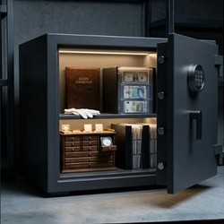 An open matte black digital security safe containing a brown coin collection album, white handling gloves, a wooden coin cabinet, and organized currency holders.
