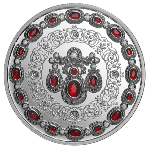 A Canadian 20 Dollar silver coin intricately set with vivid red faux rubies and clear crystals mirroring the style of royal jewelry for Queen Elizabeth II's centenary.