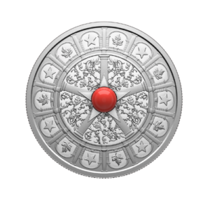 A silver collector coin featuring a prominent central star design with a bright red central gemstone