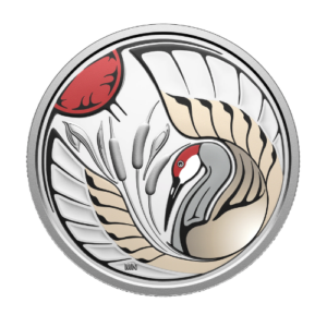 A silver collector coin featuring an Indigenous style illustration of a sandhill crane among cattails with a red sun