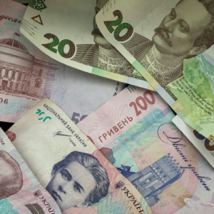 A close-up pile of colorful Ukrainian Hryvnia banknotes of various denominations