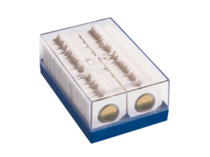 A clear plastic coin organizer box packed with white cardboard coin flips