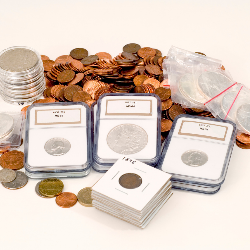 Assortment of coin collecting supplies including graded slabs, 2x2 cardboard holders, capsules, and loose coins